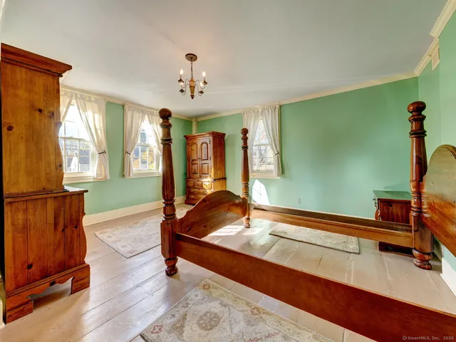 a bedroom with furniture and a window