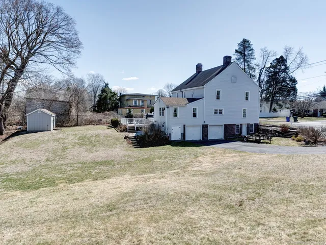 a view of a house with a yard covered in snow