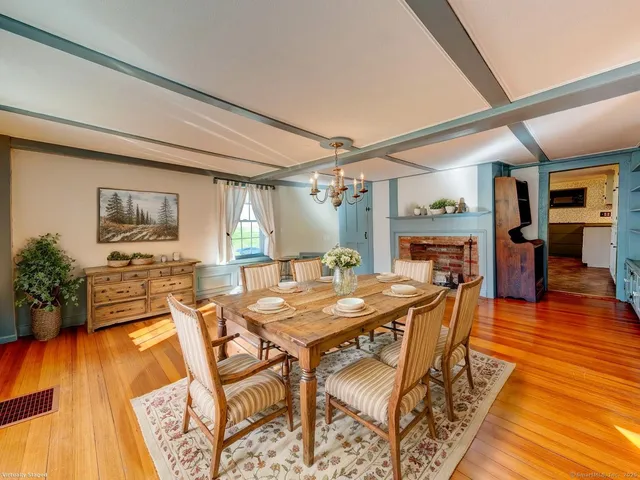 a dining room with furniture and wooden floor