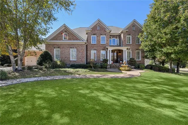 a front view of a house with a yard table and chairs