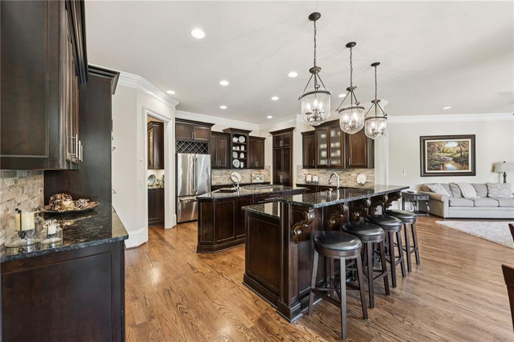 2071 Trimleston Road Statham, GA 30666 - Photo 22 of 96 a kitchen with stainless steel appliances kitchen island granite countertop a table chairs and a refrigerator
