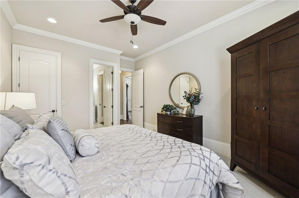 2071 Trimleston Road Statham, GA 30666 - Photo 35 of 96 a bedroom with a bed and a chandelier