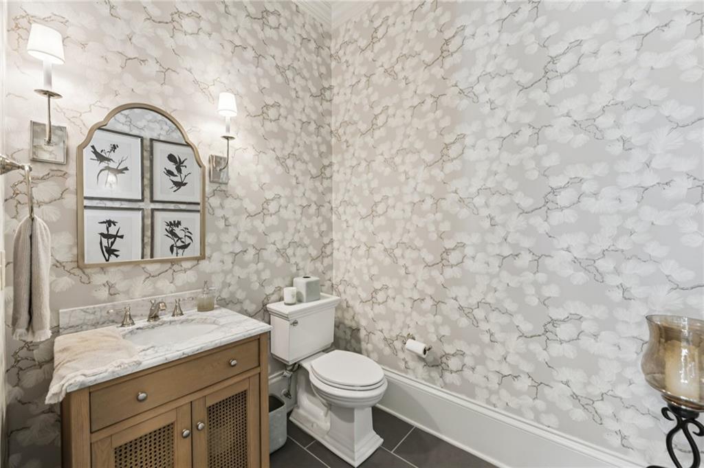 2071 Trimleston Road Statham, GA 30666 - Photo 37 of 96 a bathroom with a granite countertop toilet sink and mirror