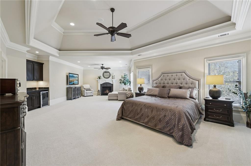 2071 Trimleston Road Statham, GA 30666 - Photo 39 of 96 a spacious bedroom with a bed a ceiling fan and a dresser
