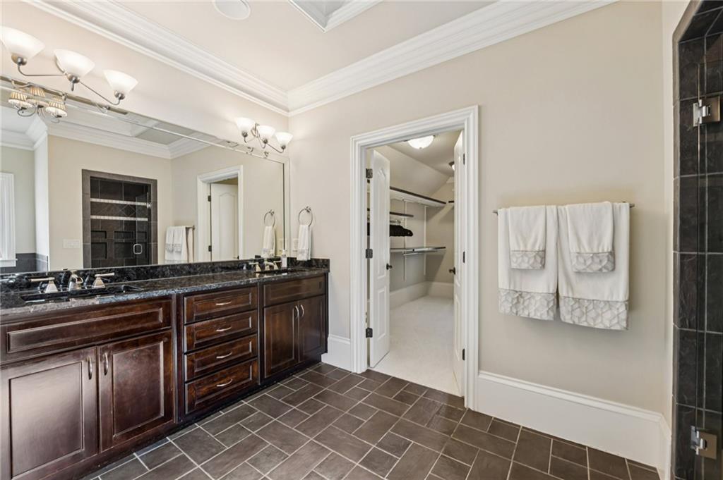 2071 Trimleston Road Statham, GA 30666 - Photo 44 of 96 a spacious bathroom with a granite countertop sink a mirror and a shower