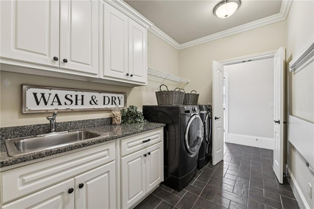 2071 Trimleston Road Statham, GA 30666 - Photo 48 of 96 a kitchen with granite countertop a sink and a washer dryer
