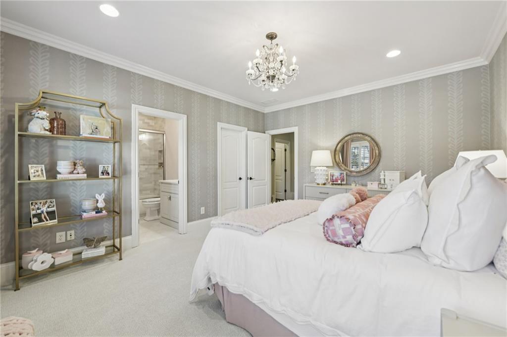 2071 Trimleston Road Statham, GA 30666 - Photo 52 of 96 a bedroom with a large bed and a chandelier