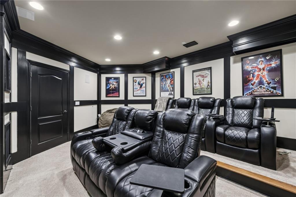 2071 Trimleston Road Statham, GA 30666 - Photo 72 of 96 a media room with lots of chairs and a projector screen