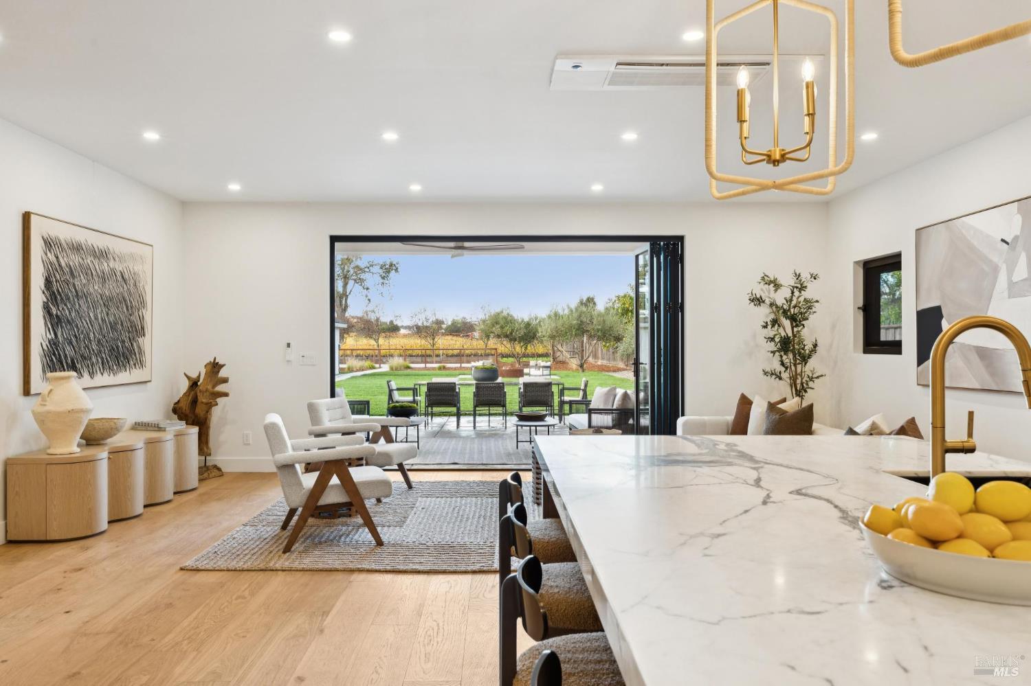 1860 McKinley Road Napa, CA 94558 - Photo 16 of 89 a living room with large couches a flat tv screen and a dining table with garden view