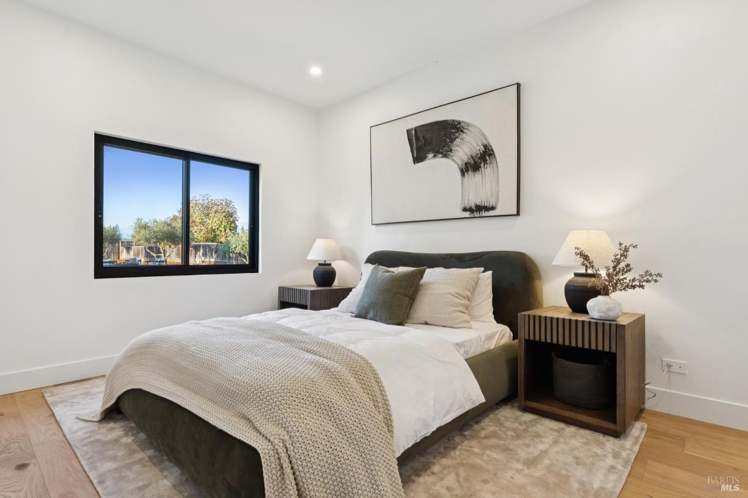 1860 McKinley Road Napa, CA 94558 - Photo 67 of 89 a bedroom with bed and wall painting with wooden floor