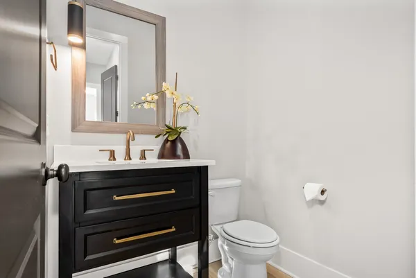 a bathroom with a toilet a sink and a mirror