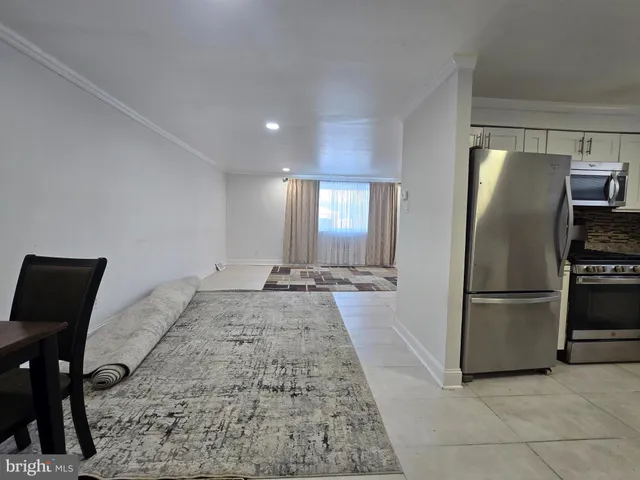 a kitchen with refrigerator and couch