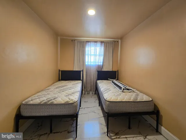a view of a room with furniture and wooden floor