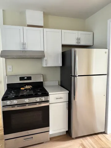a kitchen with appliances and cabinets