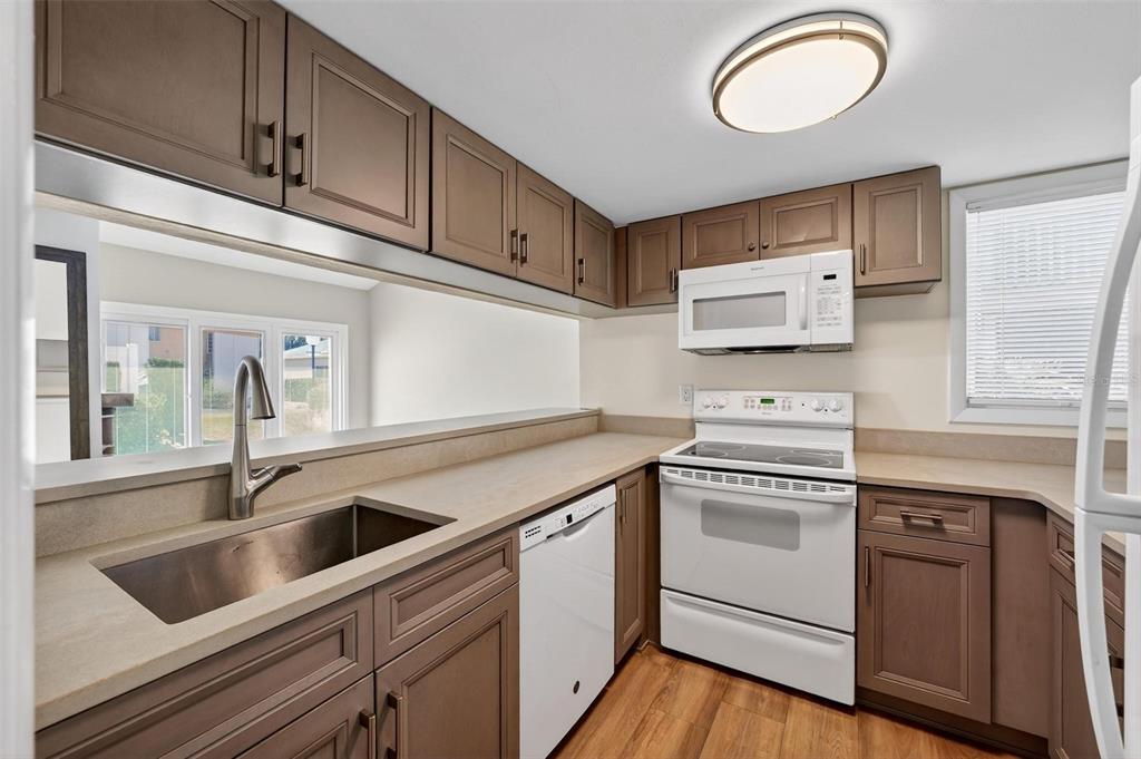 1051 South Highland Street, Unit A Mount Dora, FL 32757 - Photo 32 of 46 a kitchen with cabinets and steel stainless steel appliances