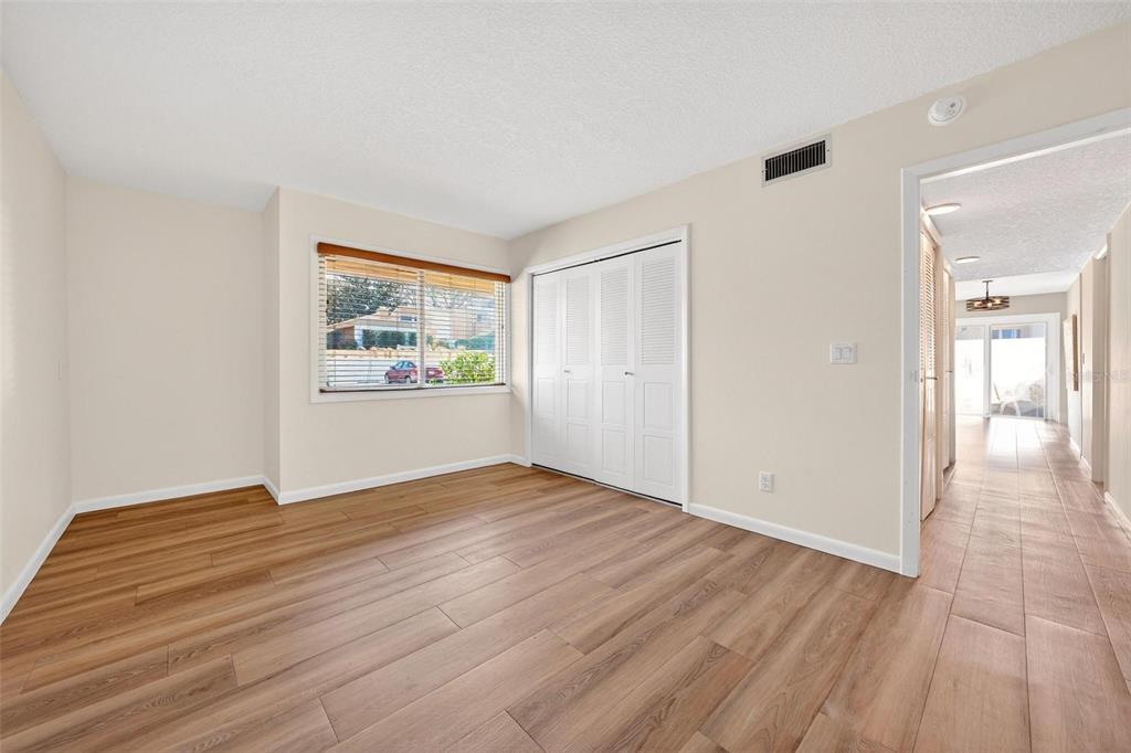 1051 South Highland Street, Unit A Mount Dora, FL 32757 - Photo 10 of 46 a view of an empty room with window and wooden floor