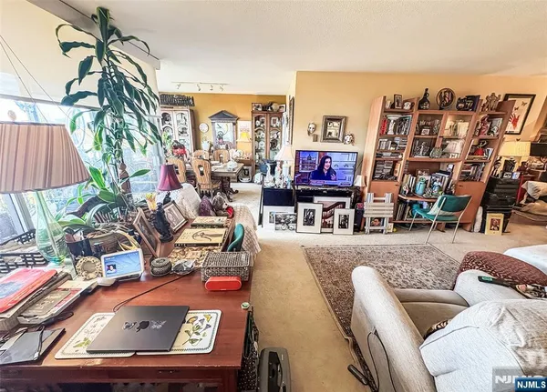 a living room with furniture a flat screen tv and a couch