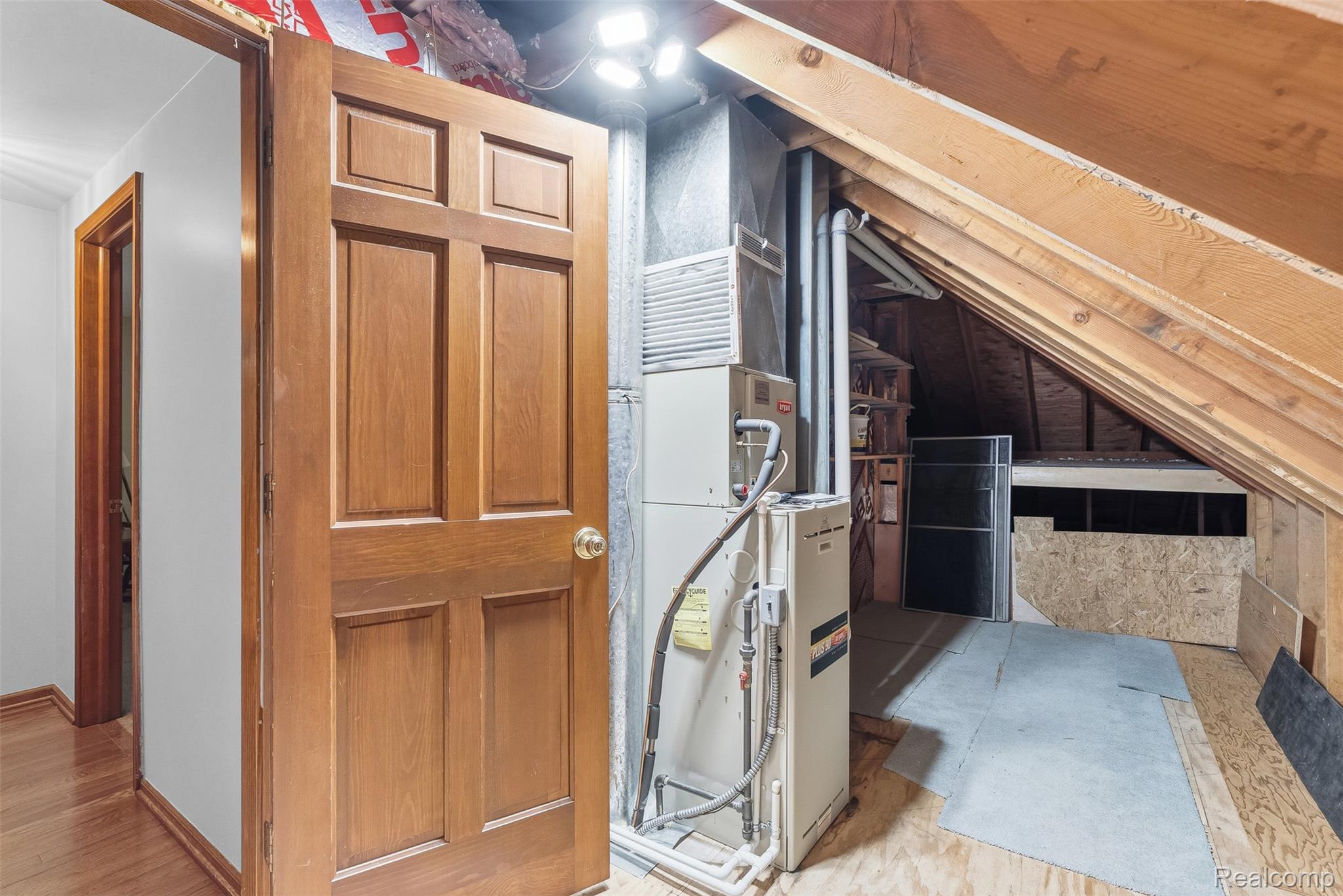 8135 Ranch Estates Road Clarkston, MI 48348 - Photo 36 of 53 Attic space featuring exposed wood beams, a mechanical unit, and plywood flooring
