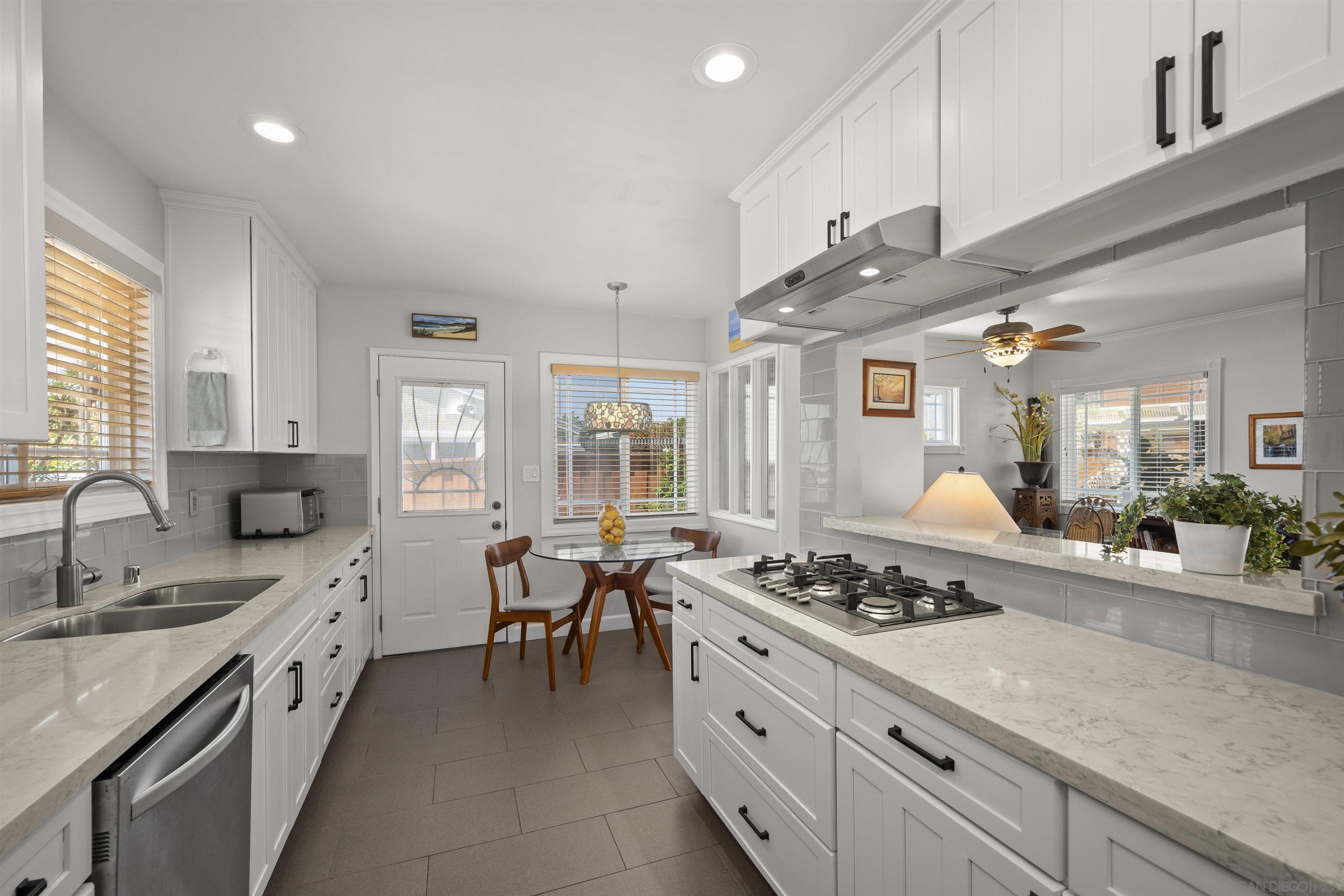 a kitchen with stainless steel appliances kitchen island granite countertop a sink stove and cabinets