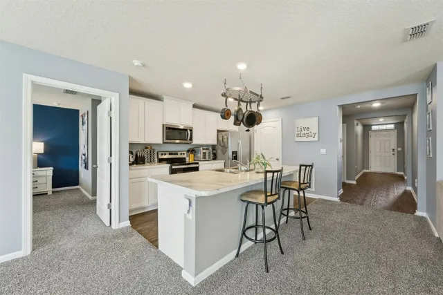 a view of a workspace with furniture and a flat screen tv