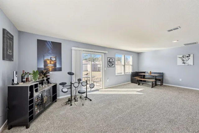 a spacious bedroom with a bed and a lamp