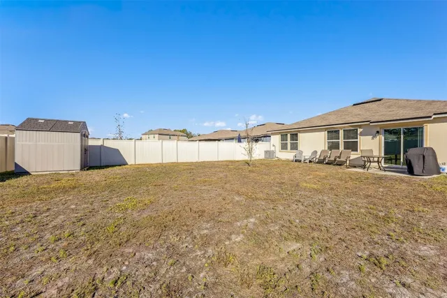 a view of a patio with a table and chairs under an umbrella