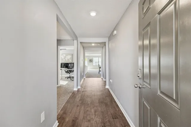 a living room with furniture white walls and kitchen view