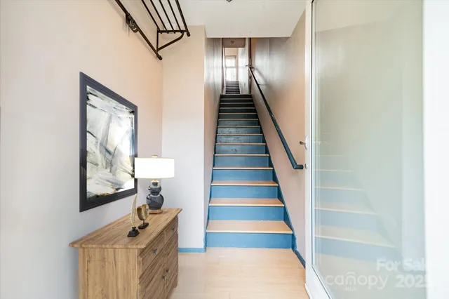 a view of entryway and hall with wooden floor