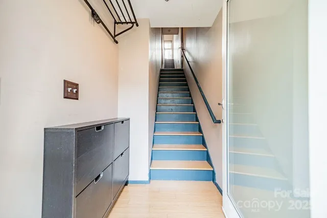a view of entryway and hall with wooden floor