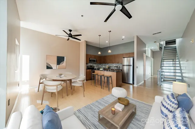 a living room with lots of furniture and a wooden floor