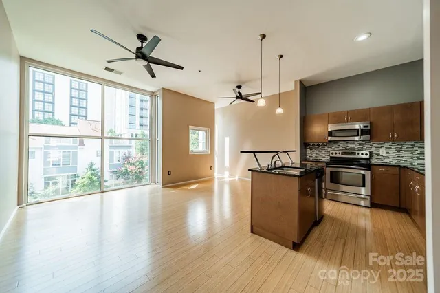 a kitchen with wooden floors and appliances