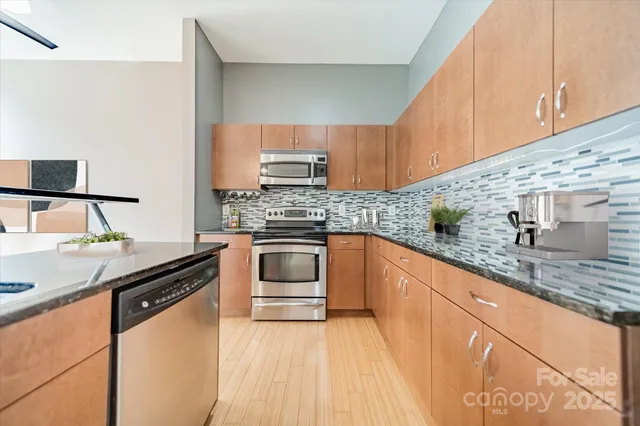 a kitchen with granite countertop a sink and cabinets