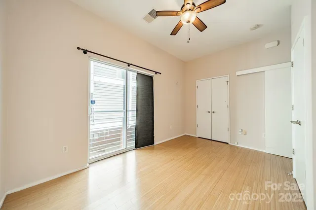 a view of empty room with ceiling fan