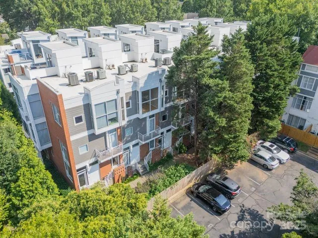 an aerial view of residential house with outdoor space and trees around