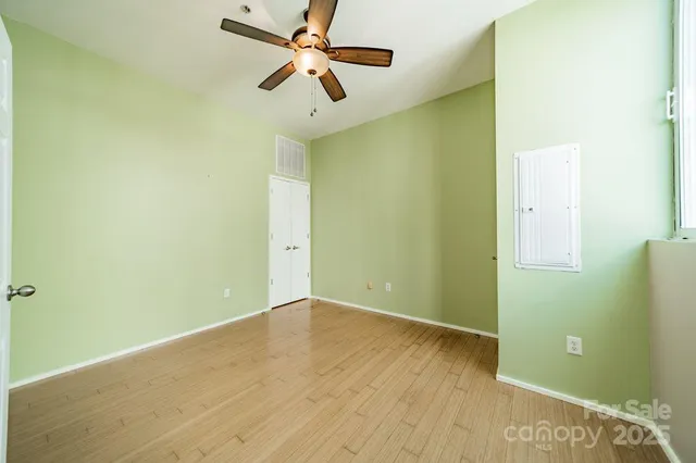 a view of room with a ceiling fan and hardwood floor