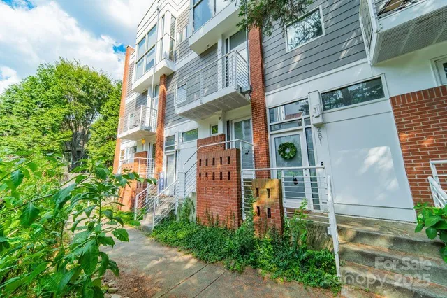 a view of a brick building next to a yard