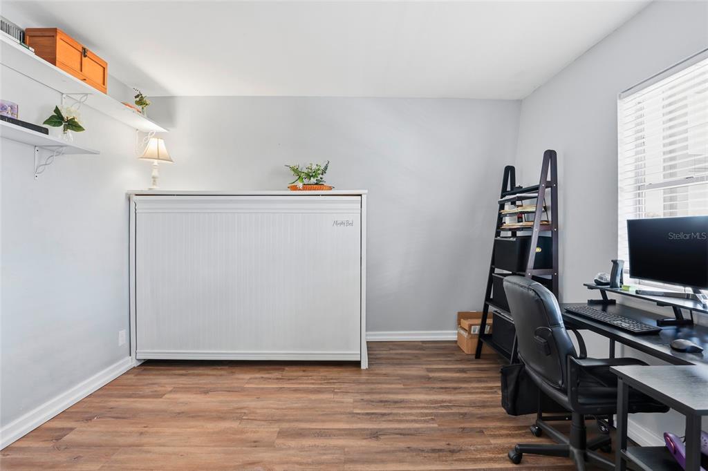 15024 Northwest 89th Street Alachua, FL 32615 - Photo 11 of 31 a view of workspace with wooden floor windows