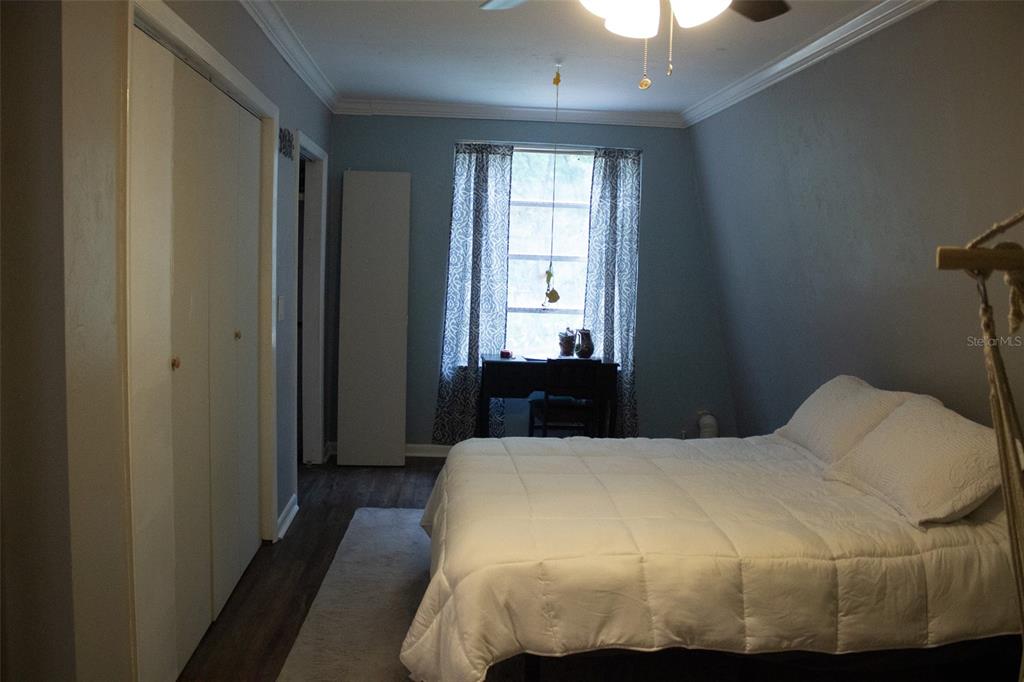 15024 Northwest 89th Street Alachua, FL 32615 - Photo 13 of 16 a bed sitting in a bedroom next to a window