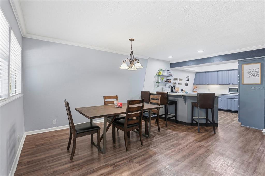 15024 Northwest 89th Street Alachua, FL 32615 - Photo 14 of 31 a view of a dining room with furniture and wooden floor