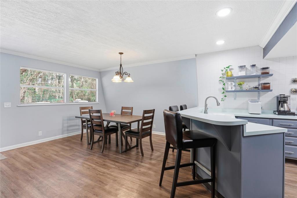 15024 Northwest 89th Street Alachua, FL 32615 - Photo 15 of 31 a view of a dining room with furniture window and wooden floor