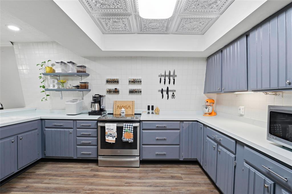 15024 Northwest 89th Street Alachua, FL 32615 - Photo 18 of 31 a kitchen with stainless steel appliances granite countertop a sink and cabinets