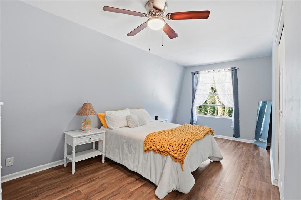 15024 Northwest 89th Street Alachua, FL 32615 - Photo 19 of 31 a bedroom with a bed and wooden floor