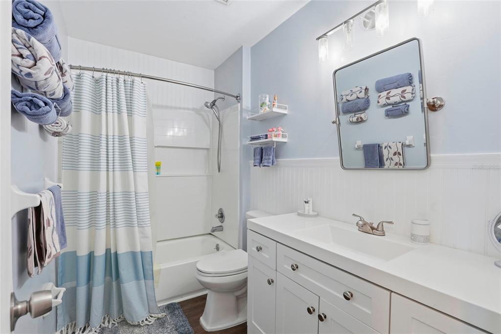 15024 Northwest 89th Street Alachua, FL 32615 - Photo 20 of 31 a bathroom with a sink a toilet and shower curtain
