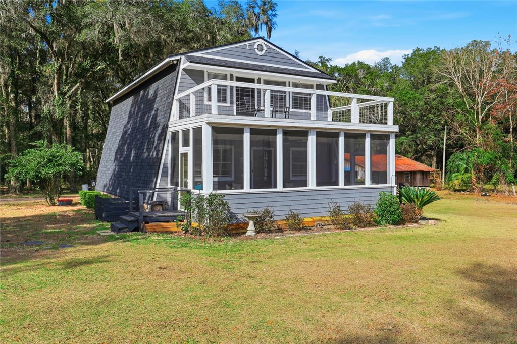 15024 Northwest 89th Street Alachua, FL 32615 - Photo 2 of 31 a front view of a house with a yard