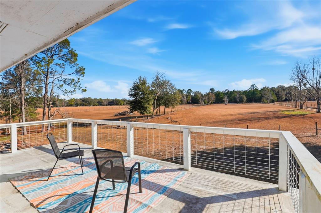 15024 Northwest 89th Street Alachua, FL 32615 - Photo 26 of 31 a view of a chairs and table on the terrace