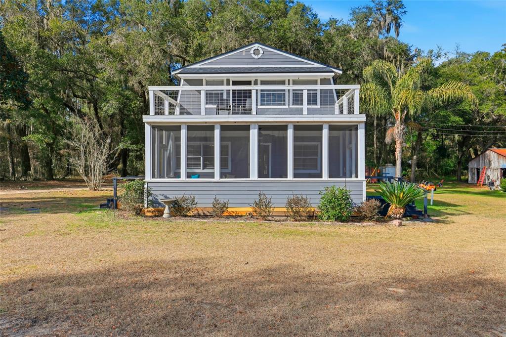 15024 Northwest 89th Street Alachua, FL 32615 - Photo 3 of 31 a front view of a house with a yard
