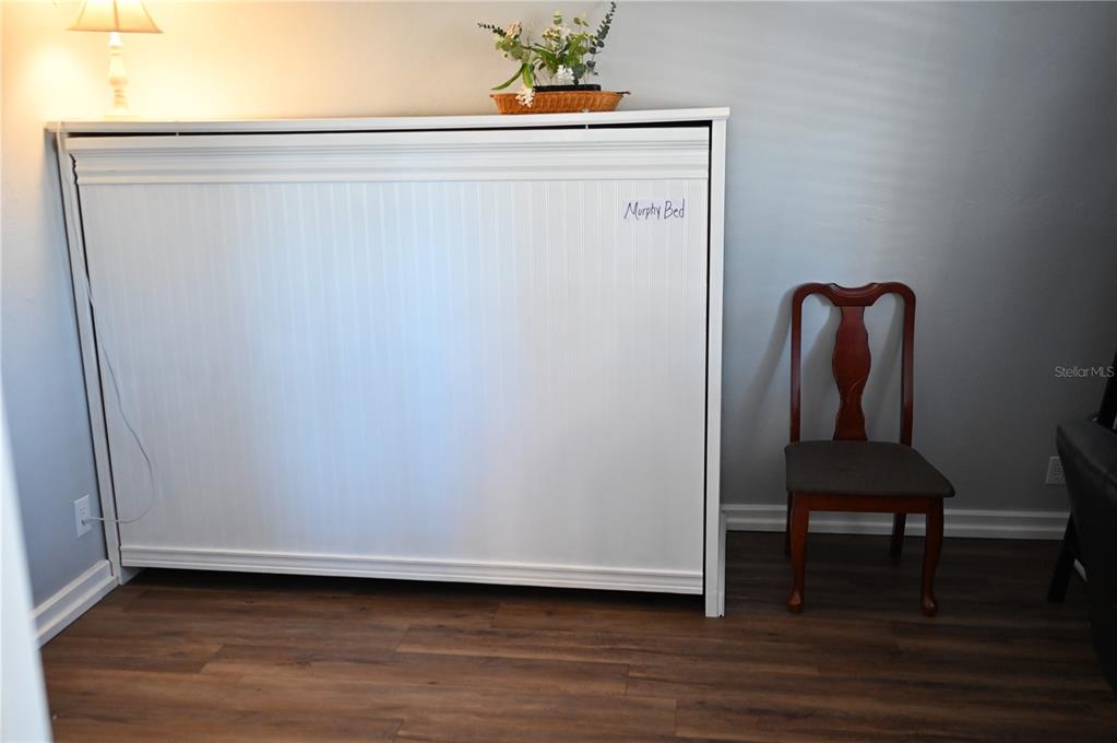 15024 Northwest 89th Street Alachua, FL 32615 - Photo 6 of 16 a view of a bench in wooden floor