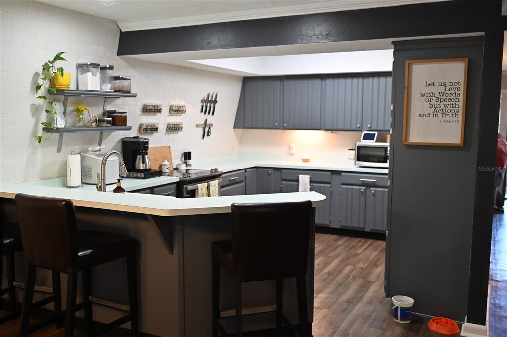 15024 Northwest 89th Street Alachua, FL 32615 - Photo 8 of 16 a kitchen with stainless steel appliances a sink and cabinets