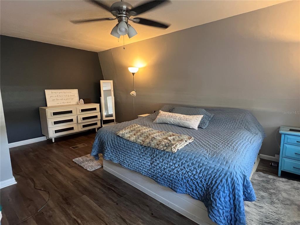 15024 Northwest 89th Street Alachua, FL 32615 - Photo 10 of 16 a bedroom with a bed and furniture