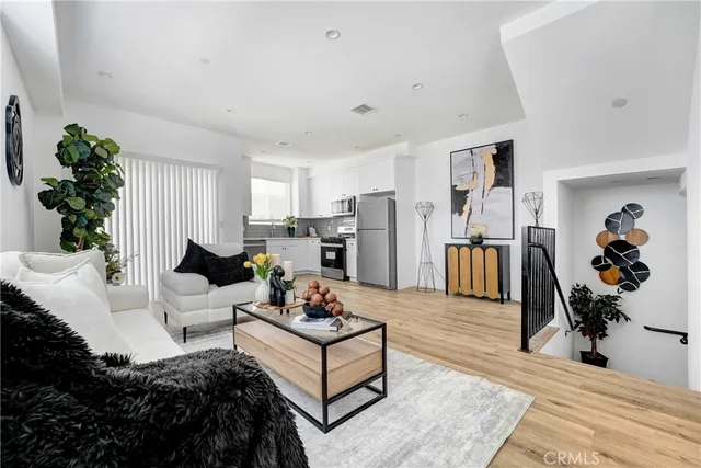 a living room with furniture and a chandelier